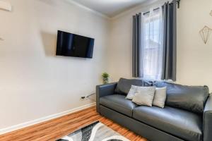 a living room with a couch and a flat screen tv at Modern 3BR2BA Apartment Minutes to NYC in Jersey City