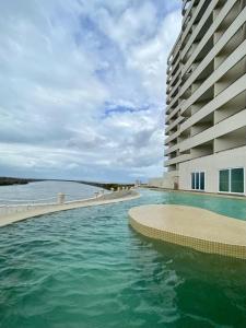 The swimming pool at or close to Departamento Riviera. Vista al mar, cerca de playa