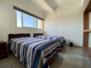 A bed or beds in a room at Departamento Riviera. Vista al mar, cerca de playa