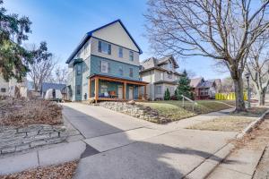 a blue house on a street with houses at Pet-Friendly Saint Paul Vacation Rental with Deck! in West Saint Paul