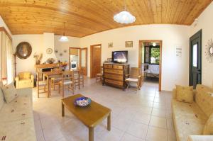 a living room with a couch and a table at Avvisania Villa in Ayia Evfimia