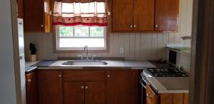 a kitchen with a sink and a window at CNP Apartments in Saint Johnʼs