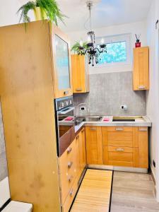 a small kitchen with wooden cabinets and a window at BB SAN SIRO in Milan