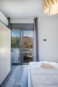 a bedroom with a bed and a view of a table at E&A luxury apartment with sea view in Rhodes Town
