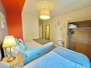 een kleine kamer met 2 bedden en een lamp bij Skyview Apartment by Noknokstay - City centre with Parking - Group, Family, Business in Sheffield