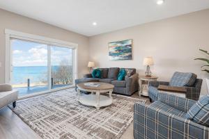 a living room with a couch and chairs and a large window at 539 Bay St in Traverse City