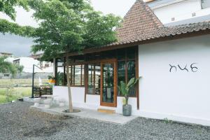 a house with a tree in front of it at Backyard Canggu in Canggu