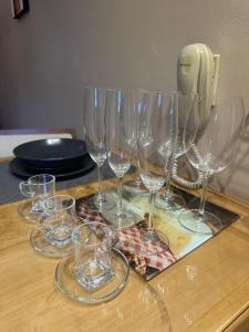 a group of wine glasses sitting on a table at Lindo loft decorado no centro c/ garagem in São Roque