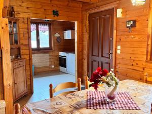 a kitchen and dining room with a table in a cabin at Chalet confortable avec cheminée à Taintrux - FR-1-589-222 in Taintrux +20 photos