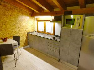 a kitchen with a refrigerator and a microwave at One bedroom property with wifi at Tubilla del Lago in Tubilla del Lago