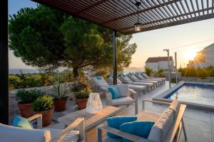 a row of lounge chairs and a swimming pool at Holiday house with a swimming pool Hvar - 22428 in Hvar