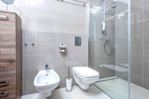a bathroom with a toilet and a glass shower at Holiday house with a swimming pool Hvar - 22428 in Hvar
