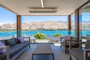 a living room with a view of the water at Lakeside Luxury 2 Bedroom Apartment in Wanaka