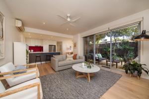 a living room with a couch and a table at Heart of Hampton by the Beach in Melbourne