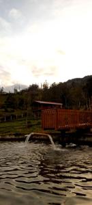 a body of water with two water fountains at Rancho Valle del Rio in Cuenca