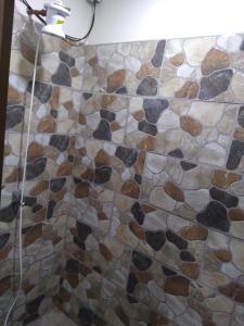 a bathroom with a shower with a mosaic floor at Rancho Valle del Rio in Cuenca