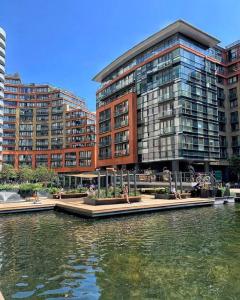 a large building next to a body of water at Luxurious Central London 1 Bed - Lake View in London