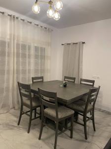 a dining room table and chairs in a room at Alwaha luxury Villa 5 Bedrooms فيلا الواحه in King Abdullah Economic City