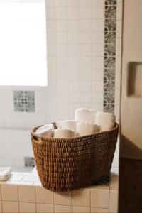 a basket of toilet paper on a counter in a bathroom at Group Getaway: Serene Adobe Retreat 4-11 guests in Albuquerque