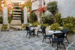 a patio with tables and chairs in a courtyard at Villa Flavia Heritage Boutique Hotel in Plovdiv