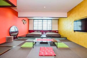 a room with two beds and a flat screen tv at Araha Resort Arapana in Chatan