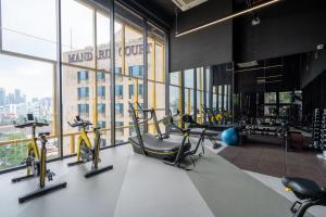 a gym with treadmills and exercise bikes in a building at Opus Signatures ChinaTown 118 in Kuala Lumpur