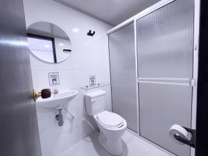 Baño blanco con aseo y lavamanos en Island Vibes, en San Andrés