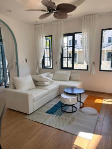 a living room with a white couch and a table at Novaworld Phan Thiết The Blue Villa in Bình Tú