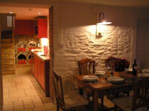a dining room with a table and a kitchen at Fishermen's Rest in Fermoy