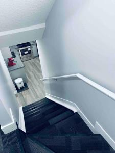 a staircase in a building with a white stair case at Cozy*Bright*Modern 2 Bedroom guest suite in Edmonton