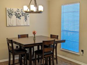 a dining room with a table and chairs and a window at The Comfort Zone in Baton Rouge