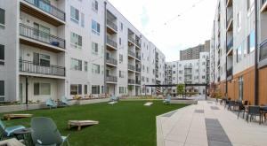 an apartment yard with chairs and a lawn in a courtyard at Cozysuites l Modern 1BR in Downtown Cincinnati in Cincinnati