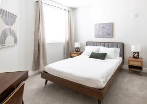 a bedroom with a large bed and a window at CozySuites Stunning 3BR in Downtown Cincinnati in Cincinnati