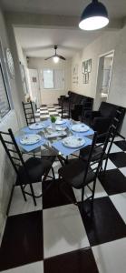 a dining room with a blue table and chairs at CASA 50 metros DA PRAIA Matinhos in Matinhos