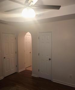 an empty room with two doors and a ceiling fan at Luxury Suite in Austell
