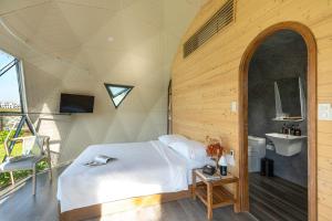 a bedroom with a bed and a sink in a room at Wonderland Resort Phan Thiet in Phan Thiet +64 photos