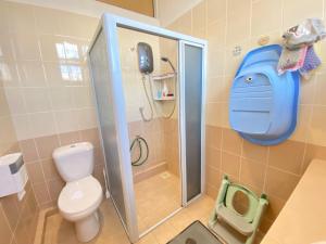 a bathroom with a shower with a toilet and a phone at 139 Homestay 13 Mins From kuching Airport Baby Friendly Spacious Home in Kota Samarahan