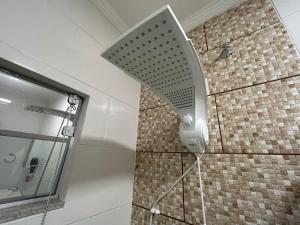 a shower head on the wall of a bathroom at BORA BORA RESIDENCE in Joinville