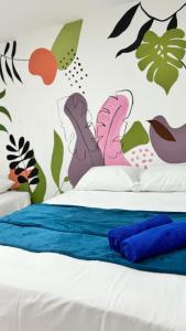 a bedroom with a bed with a butterfly wall mural at Apartamento Marbar 1 in Cartagena de Indias