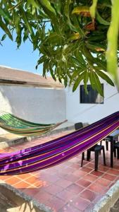 a hammock sitting under a tree next to a building at Apartamento Marbar 1 in Cartagena de Indias