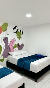 a bedroom with a bed with a mural on the wall at Apartamento Marbar 1 in Cartagena de Indias