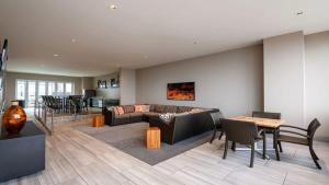a living room with a couch and a table at 16th FL Bold CozySuites with pool, gym, roof #3 in Dallas