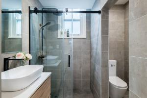 a bathroom with a shower and a sink and a toilet at Waterfront - KING Master 4 Bedroom 3 Storey#9-10 in Sydney +35 photos