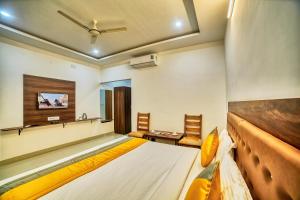 HOTEL VISA INN NEAR KEMPEGOWDA AIRPORT في بانغالور: غرفة نوم بسرير كبير ومغسلة