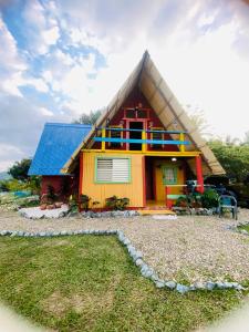 mały domek z dachem krytym strzechą w obiekcie Villa Alpina w mieście Puerto Plata