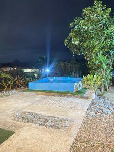 a swimming pool in a yard at night at Villa Alpina in San Felipe de Puerto Plata