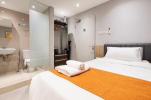 a bedroom with a bed and a bathroom with a sink at NEWLY REFURBISHED - Heritage Collection on Ann Siang in Singapore