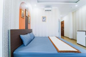 a bedroom with a blue bed in a room at The View Hotel in Vung Tau