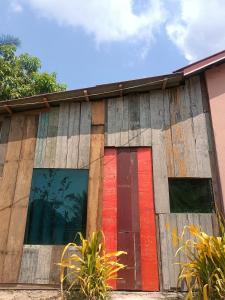 a building with colorful windows on the side of it at The Bear Bungalow in Kampot