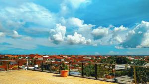 a view of a city from a balcony at Puri Saron Denpasar Hotel in Denpasar